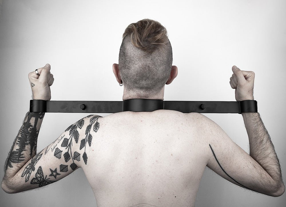 Steel wrist to neck restraint, Black from Fetters.