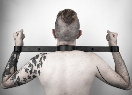 Steel wrist to neck restraint, Black from Fetters.